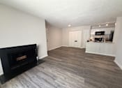 Thumbnail 11 of 25 - A living room with a fireplace and a television.