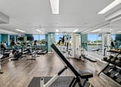 Thumbnail 17 of 22 - Fully equipped gym with weights and cardio machines at Wilton Tower apartments in Wilton Manors, FL.