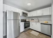 Thumbnail 1 of 22 - Renovated kitchen with stainless steel appliances at Wilton Tower apartments in Wilton Manors, Florida.