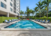 Thumbnail 2 of 22 - Resort-style swimming pool with sundeck at Wilton Tower pet-friendly apartments in Wilton Manors, FL.