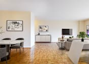 Thumbnail 51 of 66 - A modern living room with a wooden floor and a large window.