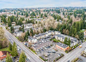 Thumbnail 32 of 35 - A view of a town from above with roads, cars, and buildings.