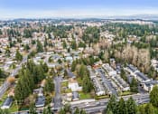 Thumbnail 33 of 35 - A bird's eye view of a suburban area with roads, houses, and trees.