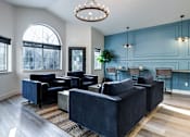 Thumbnail 11 of 35 - a living room with blue walls and a chandelier