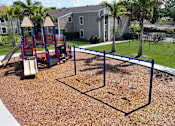 Thumbnail 16 of 23 - playground and green space at Woodlake Villas pet-friendly Orlando apartments