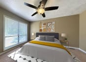 Thumbnail 10 of 17 - a bedroom with a large bed and a ceiling fan