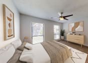 Thumbnail 5 of 17 - a bedroom with a large bed and a ceiling fan