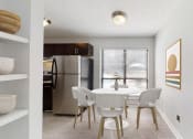 Thumbnail 7 of 17 - a dining room with a table and chairs and a stainless steel refrigerator