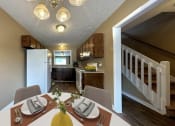 Thumbnail 12 of 17 - a dining room table with a kitchen in the background