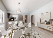 Thumbnail 6 of 17 - a dining room and kitchen area with a table and chairs