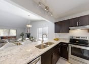 Thumbnail 8 of 17 - a kitchen with a granite counter top and a sink