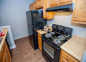 Thumbnail 3 of 20 - apartment kitchen with fridge and range