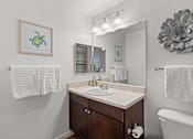 Thumbnail 15 of 30 - A bathroom with a white tub, sink, and towel rack.
