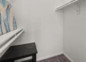 Thumbnail 13 of 30 - A small room with a table and a painting on the wall.