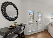 Thumbnail 4 of 30 - A black dining table with two chairs and a mirror above it.