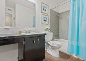Thumbnail 10 of 27 - apartment bathroom with a toilet and a shower tub