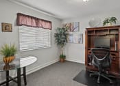 Thumbnail 19 of 27 - an office with a desk and a chair