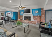 Thumbnail 16 of 27 - a living room with a brick fireplace and a television