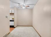 Thumbnail 11 of 28 - dining room with a ceiling fan and a kitchen in the background
