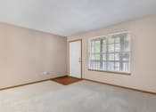 Thumbnail 13 of 28 - a bedroom with a large window and a door