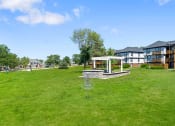 Thumbnail 21 of 28 - a large grassy area with a gazebo at apartment complex