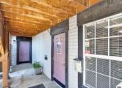 Thumbnail 15 of 28 - a door at the entrance to the leasing office with a wooden ceiling