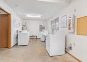Thumbnail 17 of 28 - a laundry room with washers and dryers in it