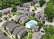 Thumbnail 26 of 28 - A bird's eye view of a residential area with houses and a swimming pool.