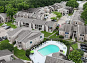 Thumbnail 25 of 28 - A bird's eye view of a residential area with houses and a swimming pool.