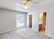 Thumbnail 11 of 28 - A room with a ceiling fan and a window.