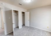 Thumbnail 16 of 28 - A room with three white closet doors.