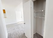 Thumbnail 13 of 28 - A white closet with shelves and a white door.