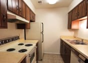 Thumbnail 2 of 13 - Apartment kitchen with oven and refrigerator