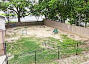 Thumbnail 18 of 32 - A backyard with a swing set and a green play structure.