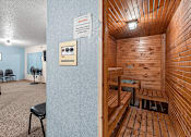 Thumbnail 4 of 9 - A room with a wooden sauna and a sign on the wall.