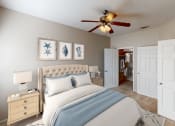 Thumbnail 9 of 24 - a bedroom with a bed and a ceiling fan