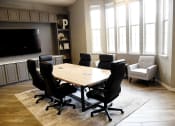 Thumbnail 15 of 24 - a conference room with a table and chairs and a tv