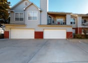 Thumbnail 23 of 24 - a car garage in front of an apartment
