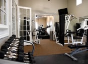 Thumbnail 19 of 24 - a apartment gym with weights and cardio equipment