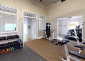 Thumbnail 17 of 24 - an apartment gym with a treadmill and weights