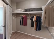 Thumbnail 6 of 24 - a walk in closet with a closet organizer and shelves