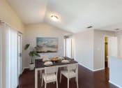 Thumbnail 3 of 24 - a dining room with a table and chairs and a painting on the wall