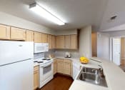 Thumbnail 4 of 24 - a kitchen with white appliances and wooden cabinets