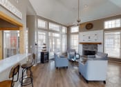 Thumbnail 14 of 24 - a living room with large windows and a fireplace