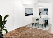 Thumbnail 8 of 32 - A dining room with a table and chairs.