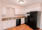 Thumbnail 1 of 27 - apartment kitchen with black appliances and white cabinets