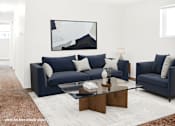 Thumbnail 17 of 32 - A living room with a blue couch and a coffee table.