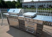 Thumbnail 25 of 32 - a stainless steel grill and barbecue on a patio