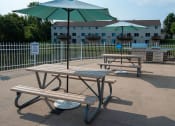 Thumbnail 23 of 32 - two picnic tables with umbrellas in a park