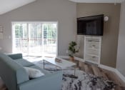 Thumbnail 12 of 32 - clubhouse at Bloomfield with blue couch and a television